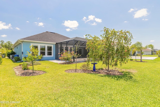 557 Mosaic Blvd, Daytona Beach, FL 32124 - rear view of property with a yard, glass enclosure, roof with shingles, and stucco siding