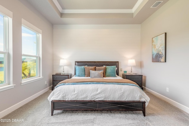 557 Mosaic Blvd, Daytona Beach, FL 32124 - bedroom featuring a tray ceiling, carpet flooring, ornamental molding, and baseboards