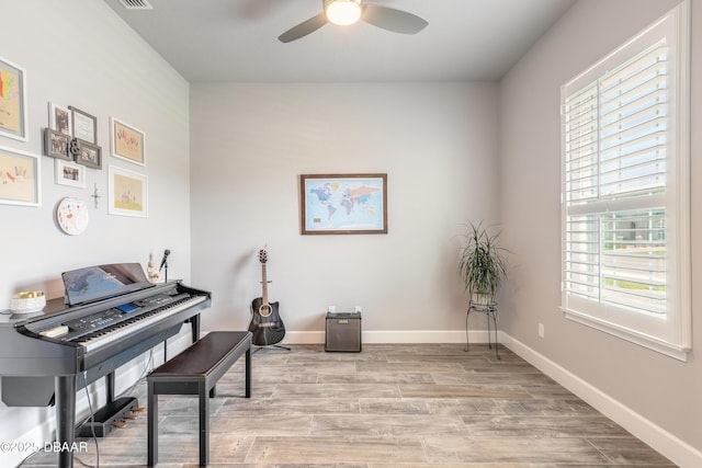 557 Mosaic Blvd, Daytona Beach, FL 32124 - living area with a ceiling fan, light wood-type flooring, and baseboards