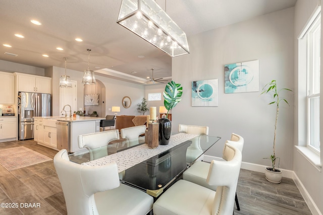 557 Mosaic Blvd, Daytona Beach, FL 32124 - dining area featuring recessed lighting, wood finished floors, ceiling fan, baseboards, and arched walkways