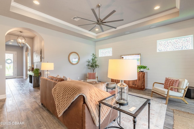 557 Mosaic Blvd, Daytona Beach, FL 32124 - living room featuring a tray ceiling, arched walkways, ceiling fan, ornamental molding, and recessed lighting