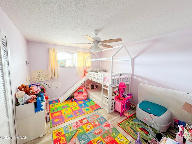 2801 N Halifax Ave Unit 250, Daytona Beach, FL 32118 - bedroom with wood finished floors, a textured ceiling, and a ceiling fan