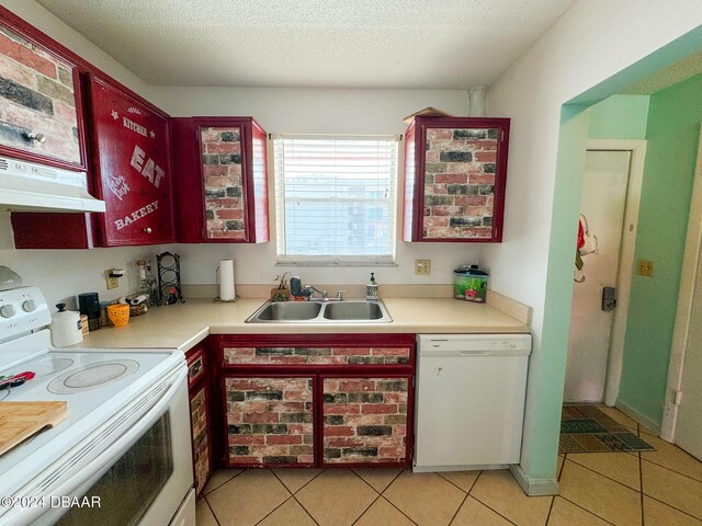 2801 N Halifax Ave Unit 250, Daytona Beach, FL 32118 - kitchen featuring white appliances, under cabinet range hood, light tile patterned floors, light countertops, and a textured ceiling