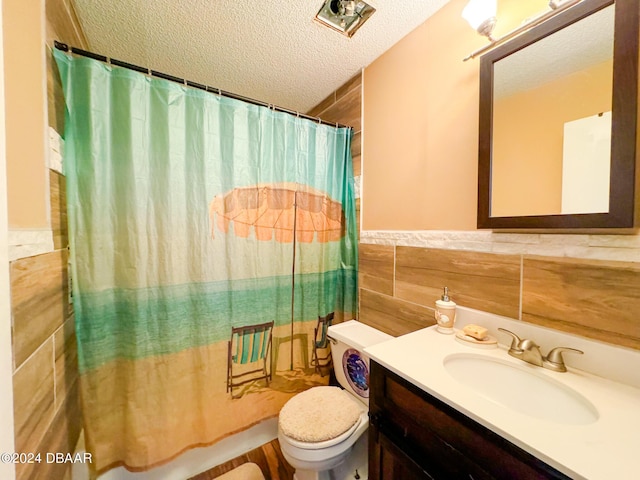 2801 N Halifax Ave Unit 250, Daytona Beach, FL 32118 - full bathroom featuring a textured ceiling, vanity, tile walls, a wainscoted wall, and a shower with shower curtain