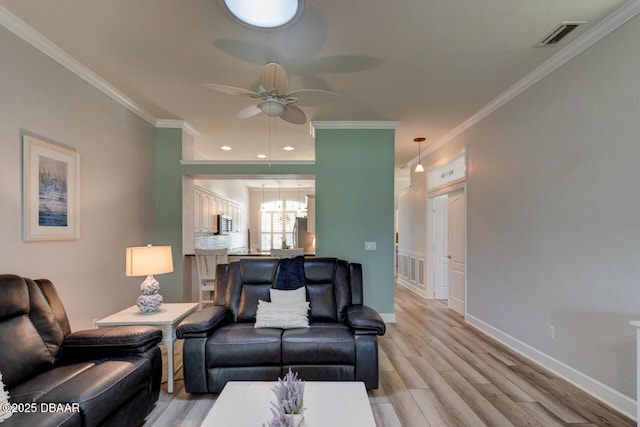 1455 Carlow Cir, Ormond Beach, FL 32174 - living area featuring a ceiling fan, light wood-style flooring, crown molding, and baseboards