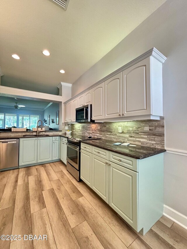 1455 Carlow Cir, Ormond Beach, FL 32174 - dining room with ceiling fan, light wood-style floors, and crown molding