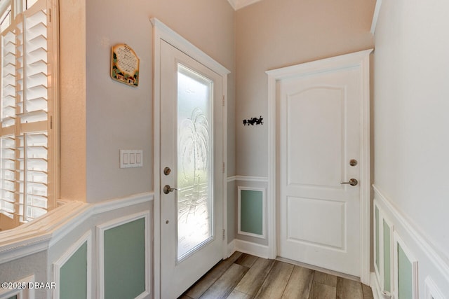 1455 Carlow Cir, Ormond Beach, FL 32174 - entryway featuring healthy amount of natural light, wood finished floors, and wainscoting