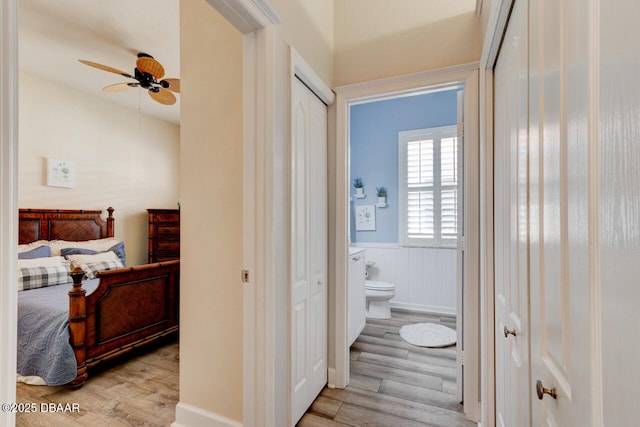 1455 Carlow Cir, Ormond Beach, FL 32174 - corridor with light wood-type flooring and a wainscoted wall