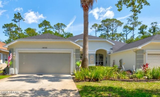 1455 Carlow Cir, Ormond Beach, FL 32174 - single story home featuring an attached garage, concrete driveway, stucco siding, and roof with shingles