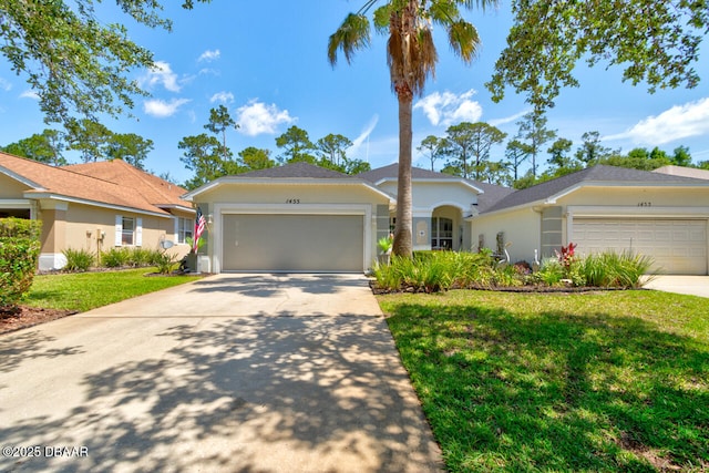 1455 Carlow Cir, Ormond Beach, FL 32174 - single story home featuring an attached garage, concrete driveway, stucco siding, and a front lawn