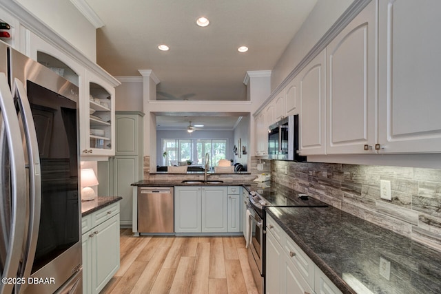 1455 Carlow Cir, Ormond Beach, FL 32174 - kitchen featuring appliances with stainless steel finishes, a sink, ornamental molding, light wood-type flooring, and tasteful backsplash