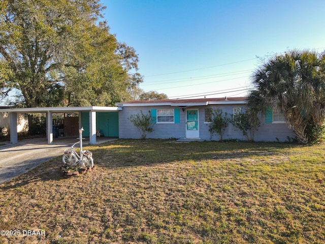 ranch-style house with a carport and a front lawn