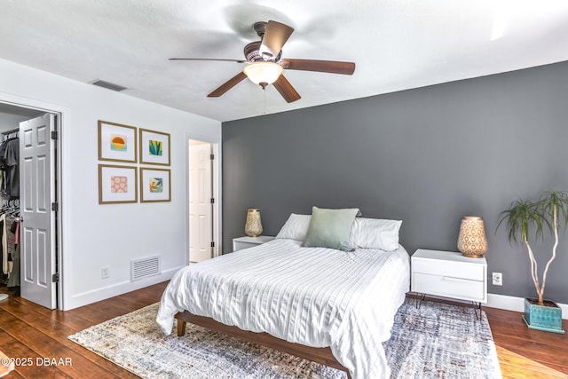 887 Sugar House Ct, Port Orange, FL 32129 - bedroom featuring a walk in closet, wood finished floors, and a ceiling fan