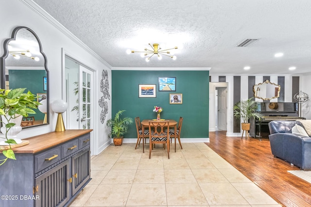 887 Sugar House Ct, Port Orange, FL 32129 - dining space with crown molding, a chandelier, a textured ceiling, and light tile patterned flooring