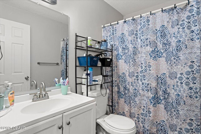 bathroom with a textured ceiling, vanity, toilet, and a shower with curtain