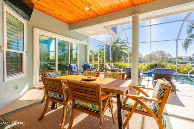 sunroom featuring outdoor dining area