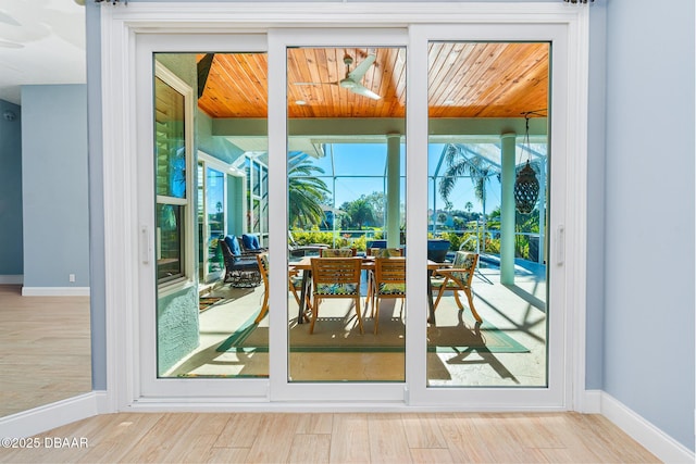 entryway with baseboards and wood finished floors