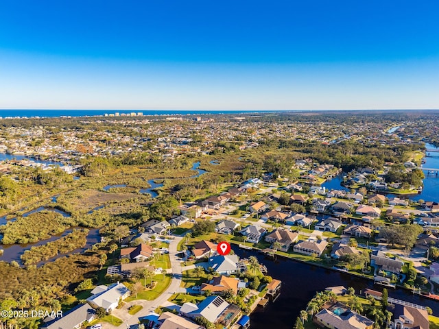 drone / aerial view featuring a residential view and a water view