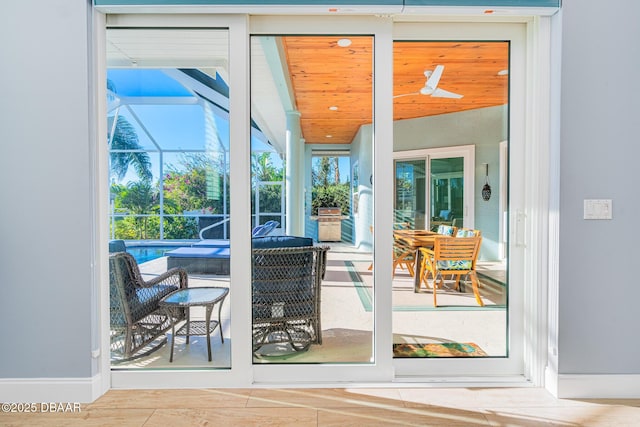 entryway featuring baseboards, lofted ceiling, and a sunroom