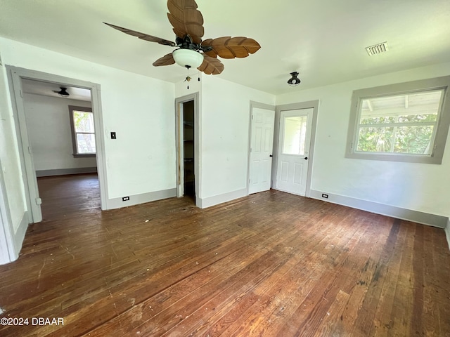 interior space with ceiling fan, a closet, and dark wood-type flooring