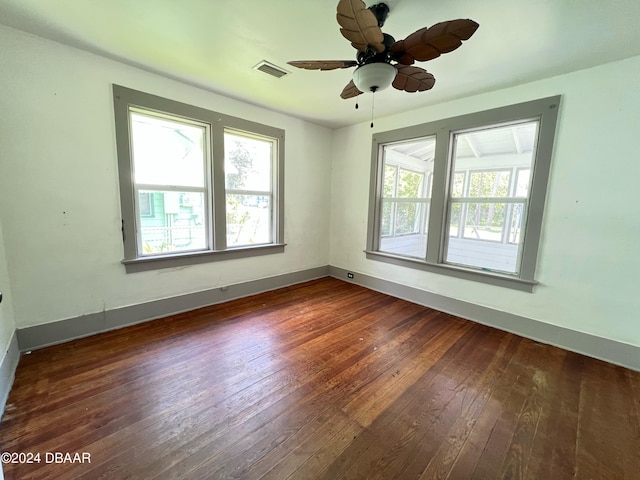 spare room with ceiling fan and dark hardwood / wood-style floors