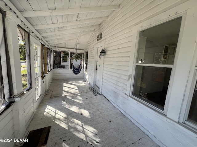 unfurnished sunroom featuring lofted ceiling and wooden ceiling