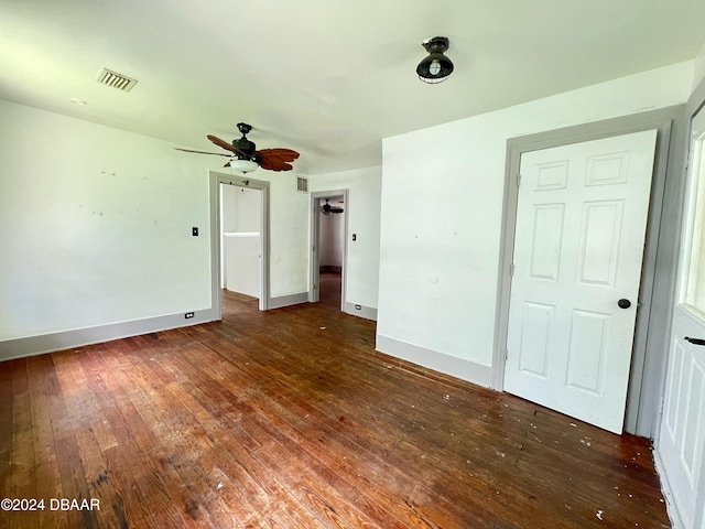 spare room featuring ceiling fan and dark hardwood / wood-style floors