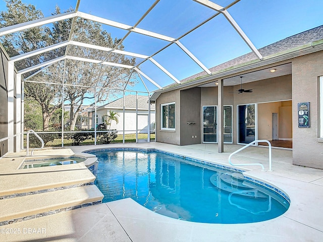 view of swimming pool with an in ground hot tub, ceiling fan, glass enclosure, and a patio