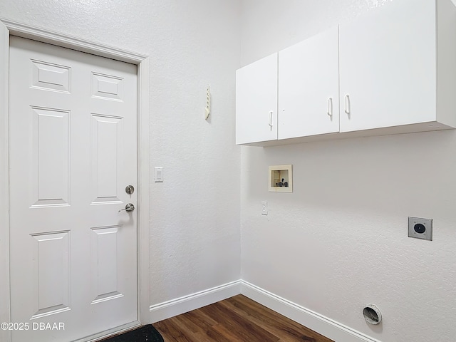 clothes washing area with hookup for a washing machine, dark hardwood / wood-style floors, hookup for an electric dryer, and cabinets