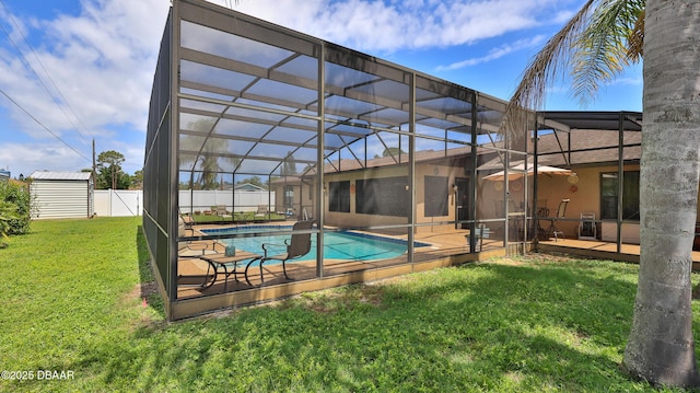 view of pool featuring fence, a patio, a fenced in pool, glass enclosure, and a yard