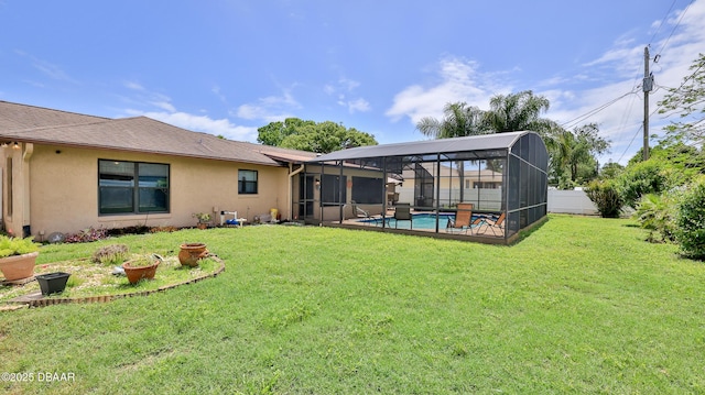 back of property with a fenced in pool, a lawn, stucco siding, and fence private yard
