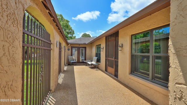 view of home's exterior with french doors and stucco siding