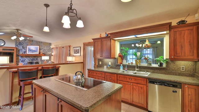 kitchen with dishwasher, a center island, black electric cooktop, a sink, and light tile patterned floors