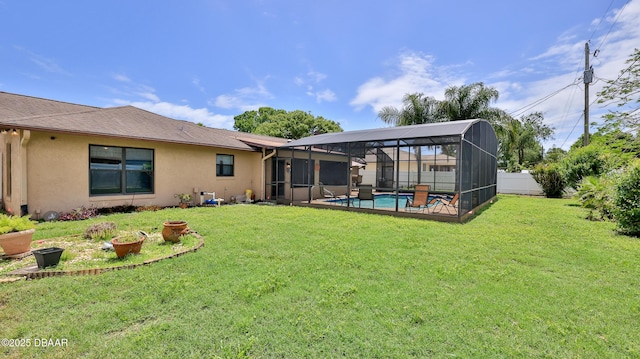 rear view of house featuring a fenced in pool, stucco siding, a yard, and a fenced backyard