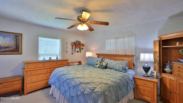 bedroom featuring ceiling fan and light colored carpet