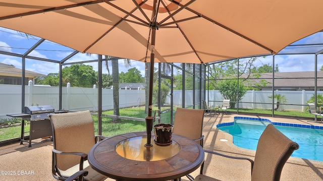 view of swimming pool with glass enclosure, a fenced in pool, a fenced backyard, a patio, and a grill
