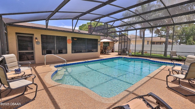 view of swimming pool with glass enclosure, fence, a fenced in pool, and a patio area