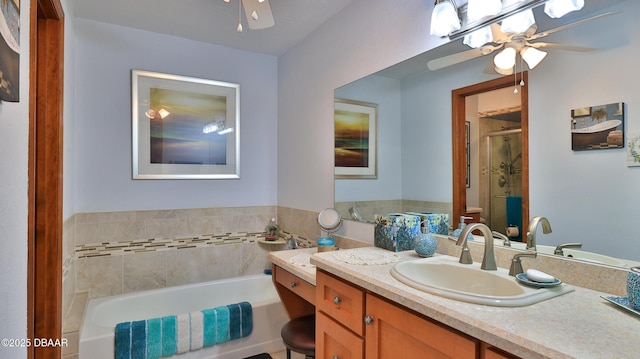 full bathroom featuring vanity, a ceiling fan, a bath, and a shower stall