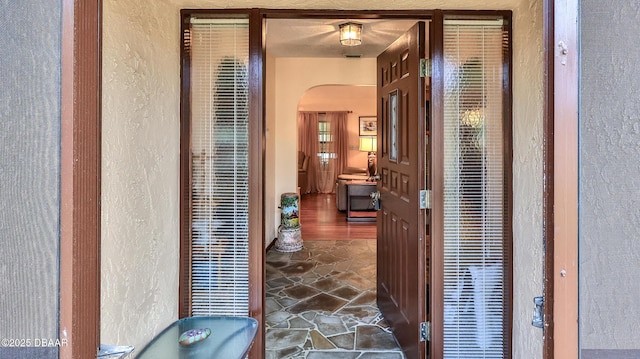 2504 Sabal Palm Dr, Edgewater, FL 32141 - hall with arched walkways, a textured wall, and a heating unit