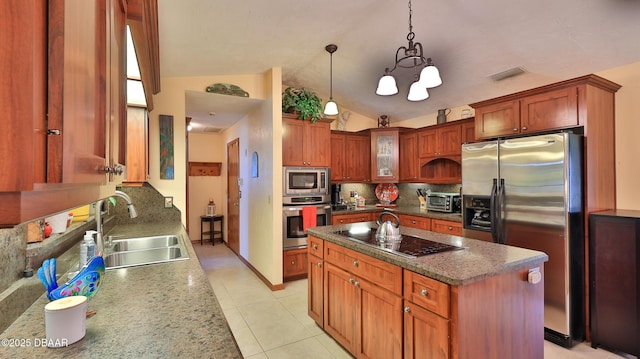 kitchen with visible vents, glass insert cabinets, a sink, backsplash, and stainless steel appliances