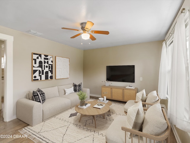 living room featuring light wood-type flooring and ceiling fan