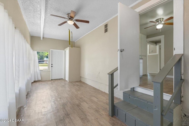 2300 Calloway Dr, Orlando, FL 32810 - unfurnished living room with a ceiling fan, wood finished floors, a textured ceiling, and stairway