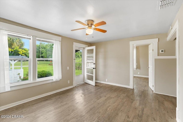 unfurnished room with ceiling fan and wood-type flooring