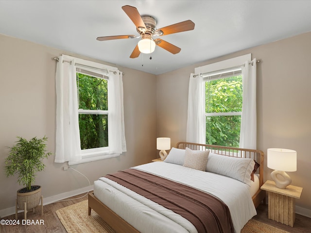 2300 Calloway Dr, Orlando, FL 32810 - bedroom with multiple windows, wood finished floors, and a ceiling fan