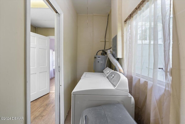2300 Calloway Dr, Orlando, FL 32810 - laundry room featuring water heater, wood finished floors, separate washer and dryer, and electric panel