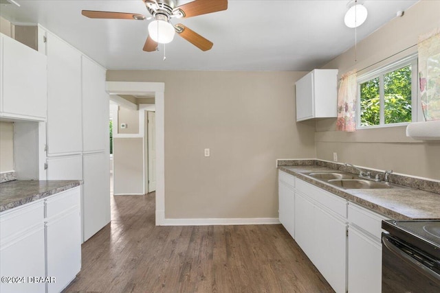 2300 Calloway Dr, Orlando, FL 32810 - kitchen featuring dark wood-style flooring, white cabinets, ceiling fan, and black range oven
