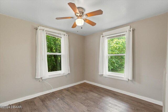 2300 Calloway Dr, Orlando, FL 32810 - bedroom featuring multiple windows, wood finished floors, and a ceiling fan