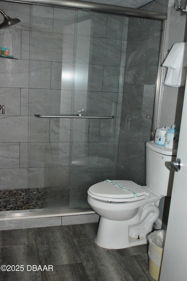 bathroom featuring an enclosed shower and toilet