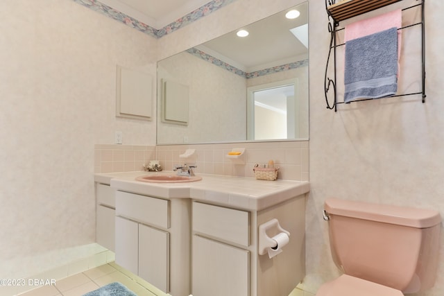 bathroom with toilet, tile patterned flooring, decorative backsplash, and vanity