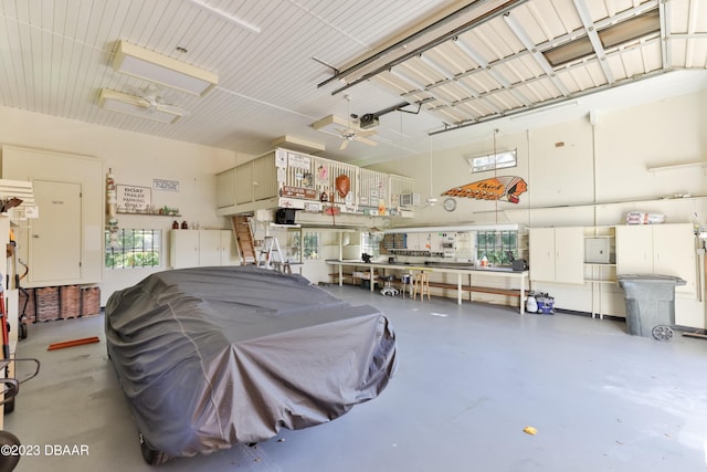 garage with a workshop area and a garage door opener